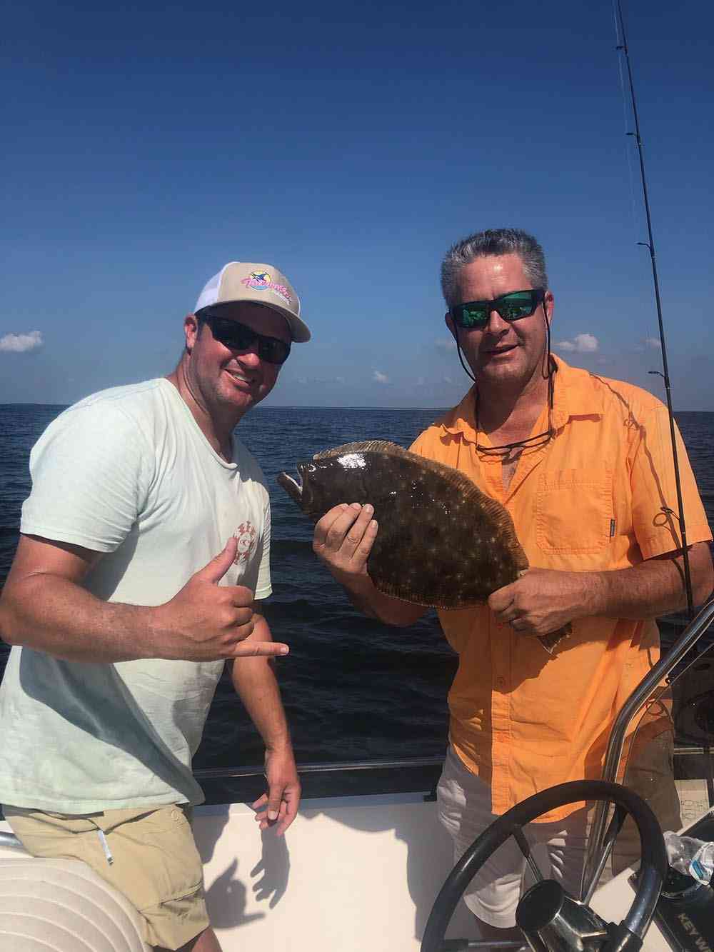 a fisherman with a flounder
