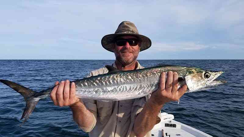 a fisherman with a kingfish