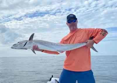 a fisherman with a kingfish