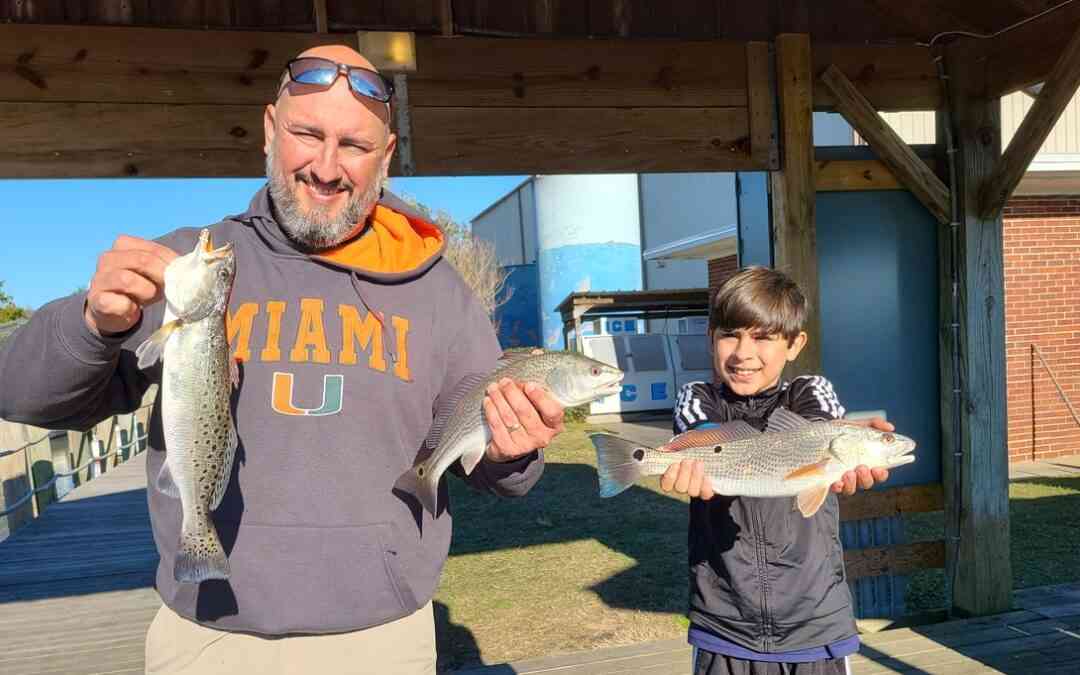 anglers with redfish and seatrout