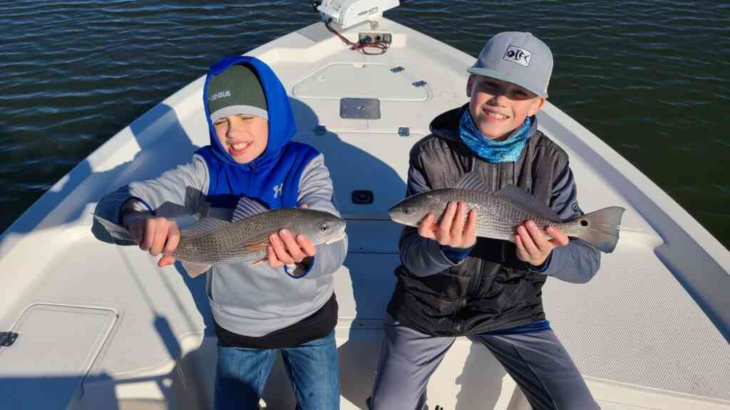 two anglers with redfish