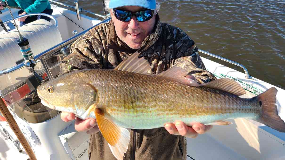 fisherman with a redfish