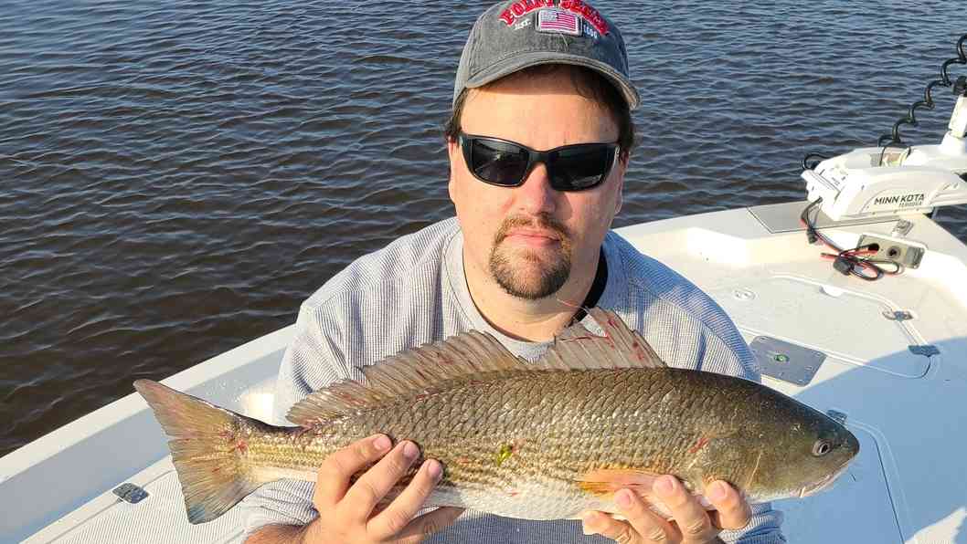 fisherman with a redfish