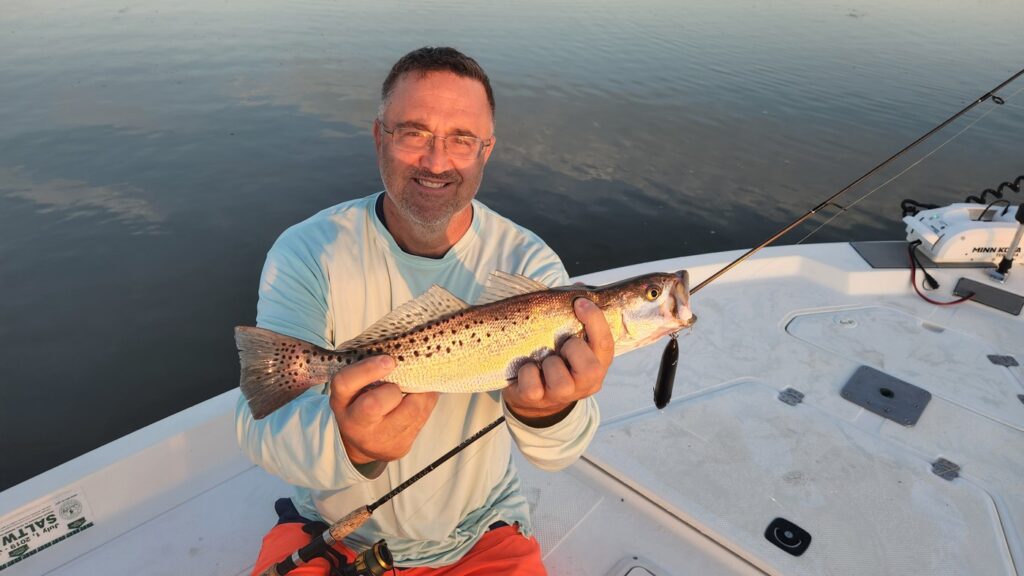 Bull reds kept bending the hooks, but Patrick got this nice trout on topwater
