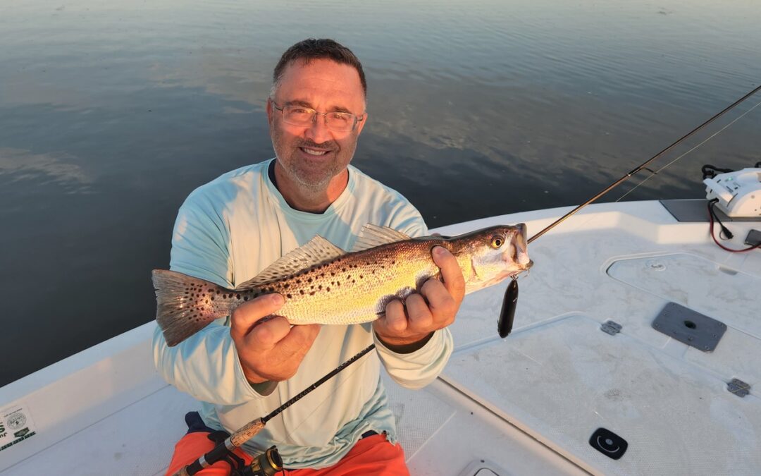 man holding spotted seatrout in myrtle beach, south carolina