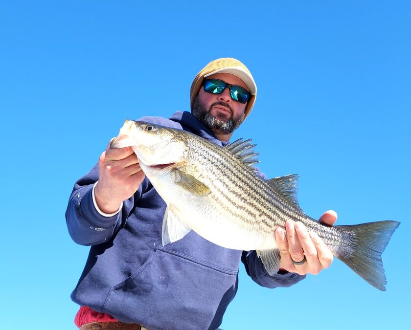 man with striped bass