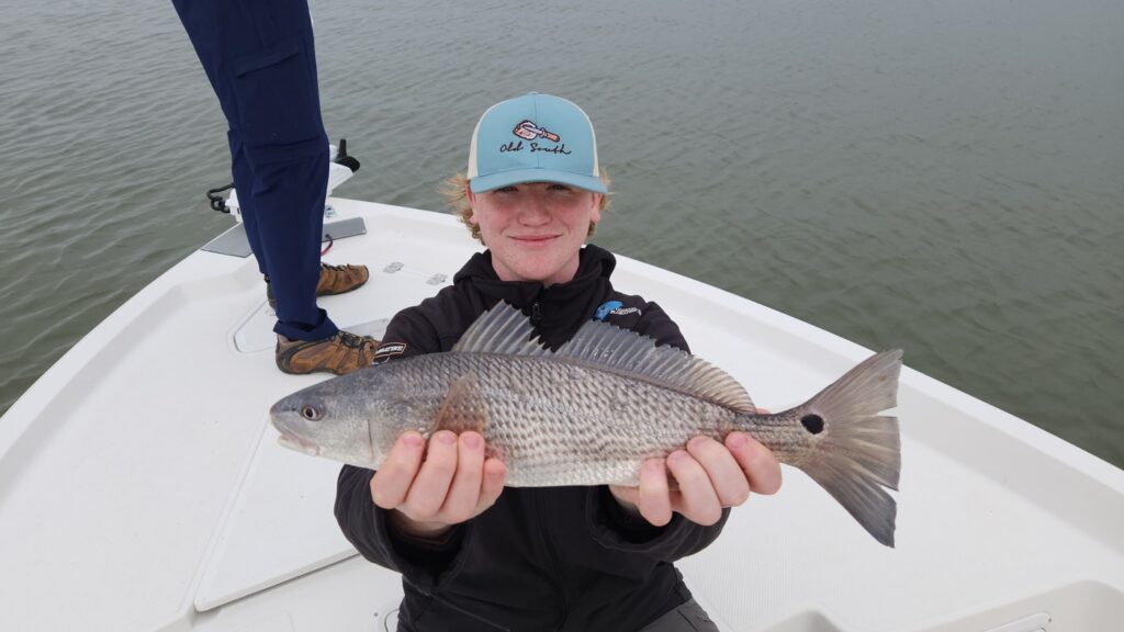 person holding redfish