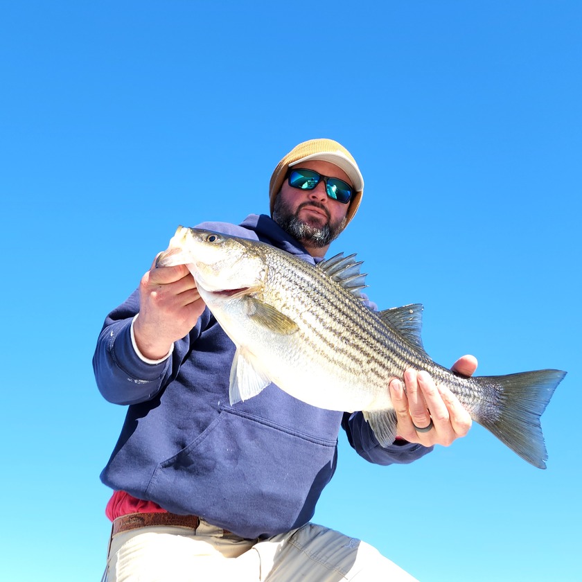 man with striped bass