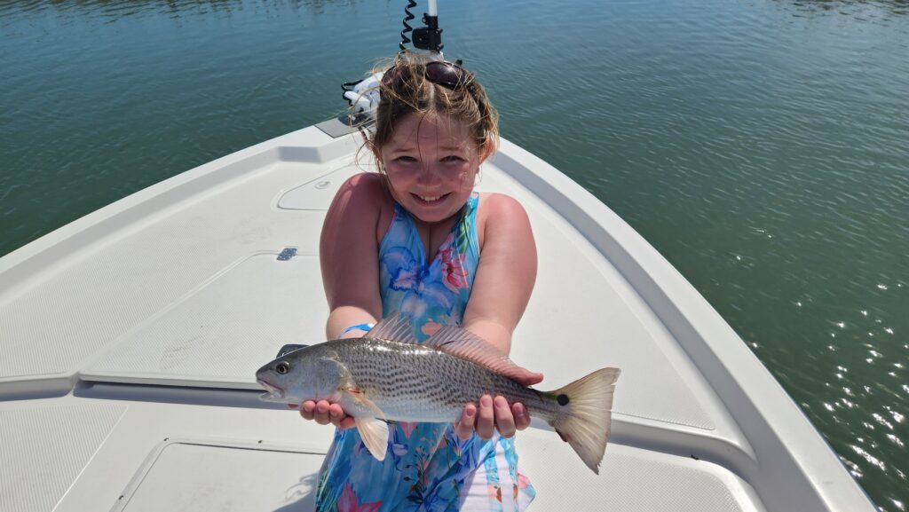 girl with redfish in pawleys island