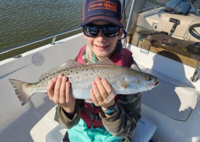kid with speckled trout