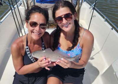 mother and daughter holding fish