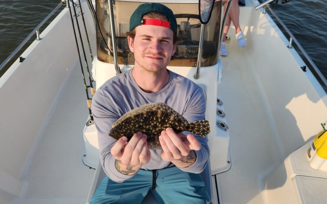 man holding flounder