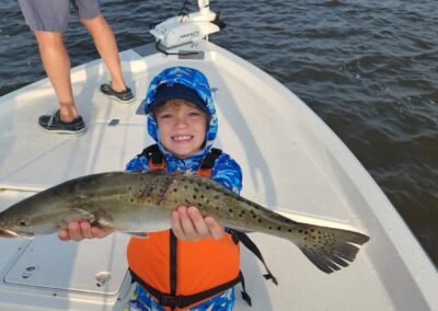 kid holding gator trout