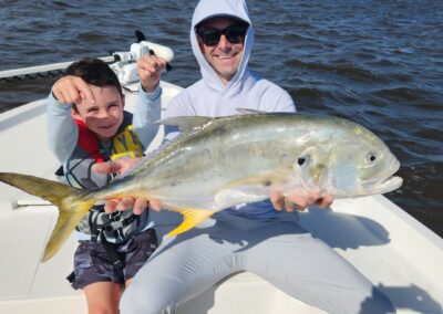 man and son holding jack crevalle fish in myrtle beach