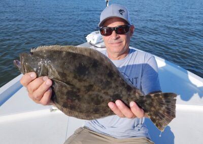 man holding doormat flounder