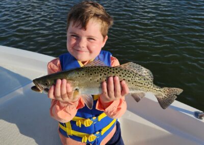 kid fishing with speckled trout