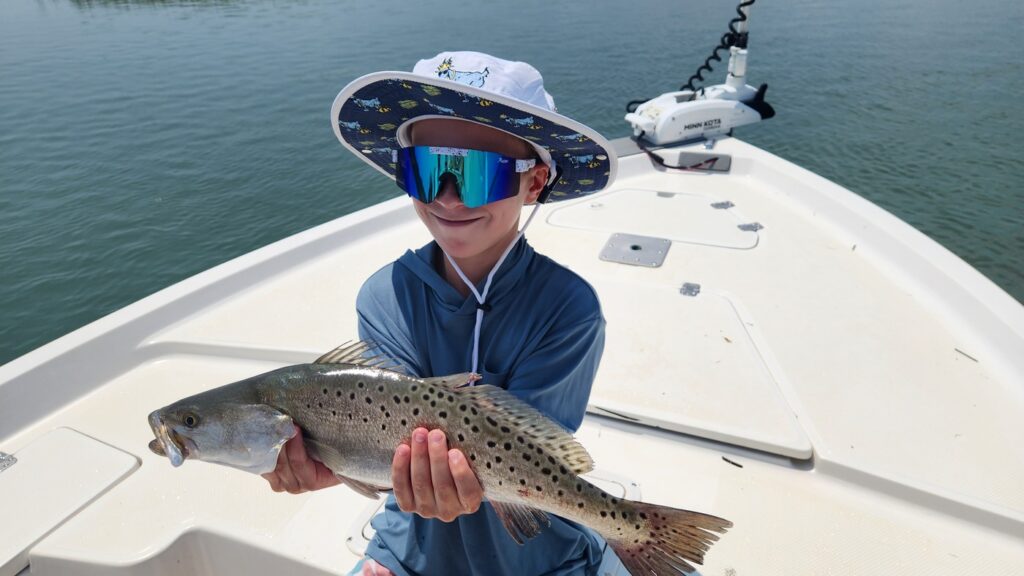 boy holding speckled trout in georgetown