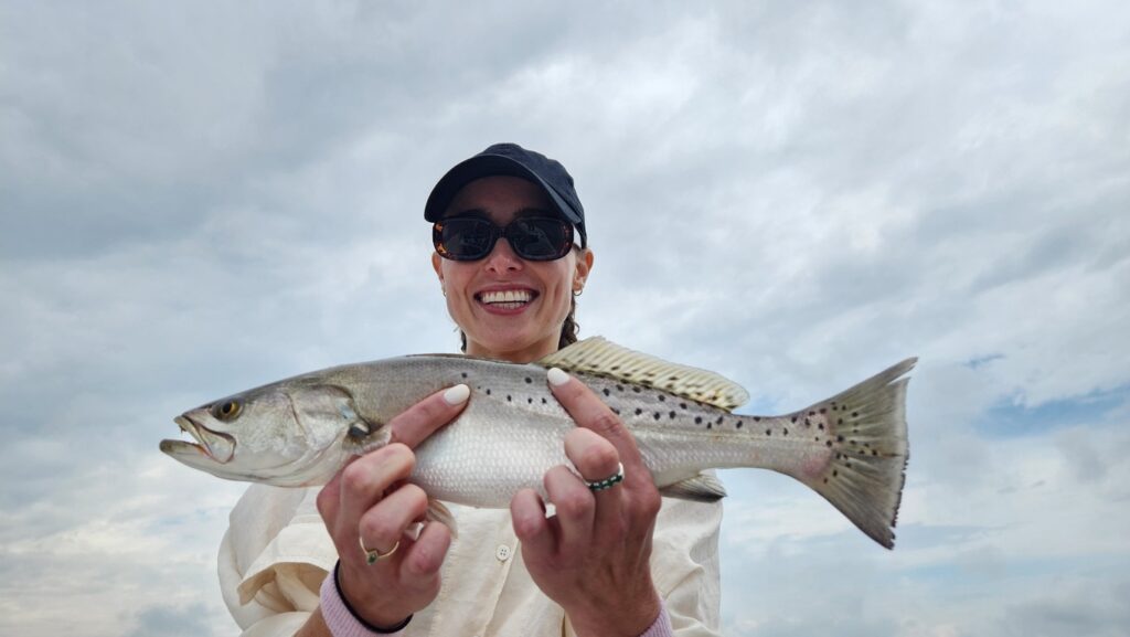 woman holding speckled trout in myrtle beach