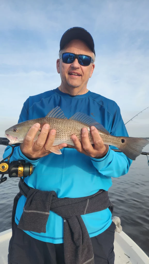 April 2025 Fishing Report for Myrtle Beach man holding red drum fish in myrtle beach