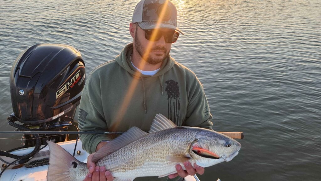 angler holding a red drum fish caught on topwater near myrtle beach